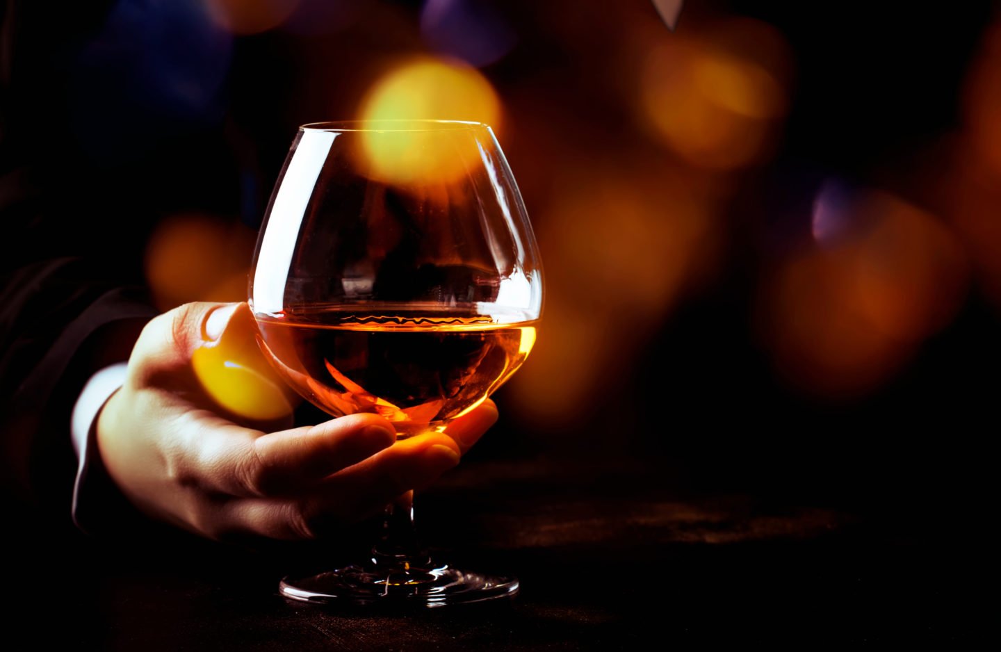 handheld glass of cognac