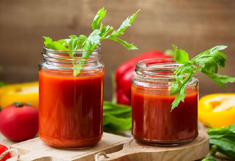 Jars of Bloody Mary Cocktail with a celery garnish