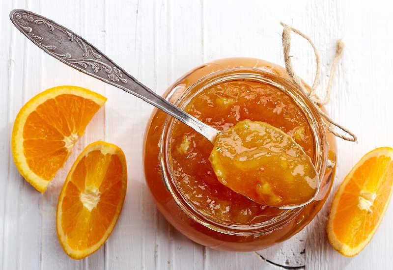 Marmalade in a jar and a spoon