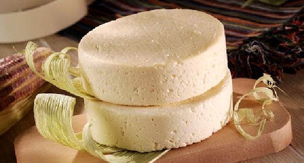 Queso fresco rounds on a chopping board