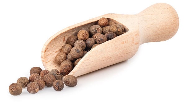 Whole allspice in a scoop