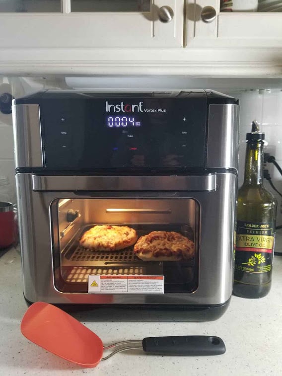 The Instant Vortex Oven with a couple small pizzas inside