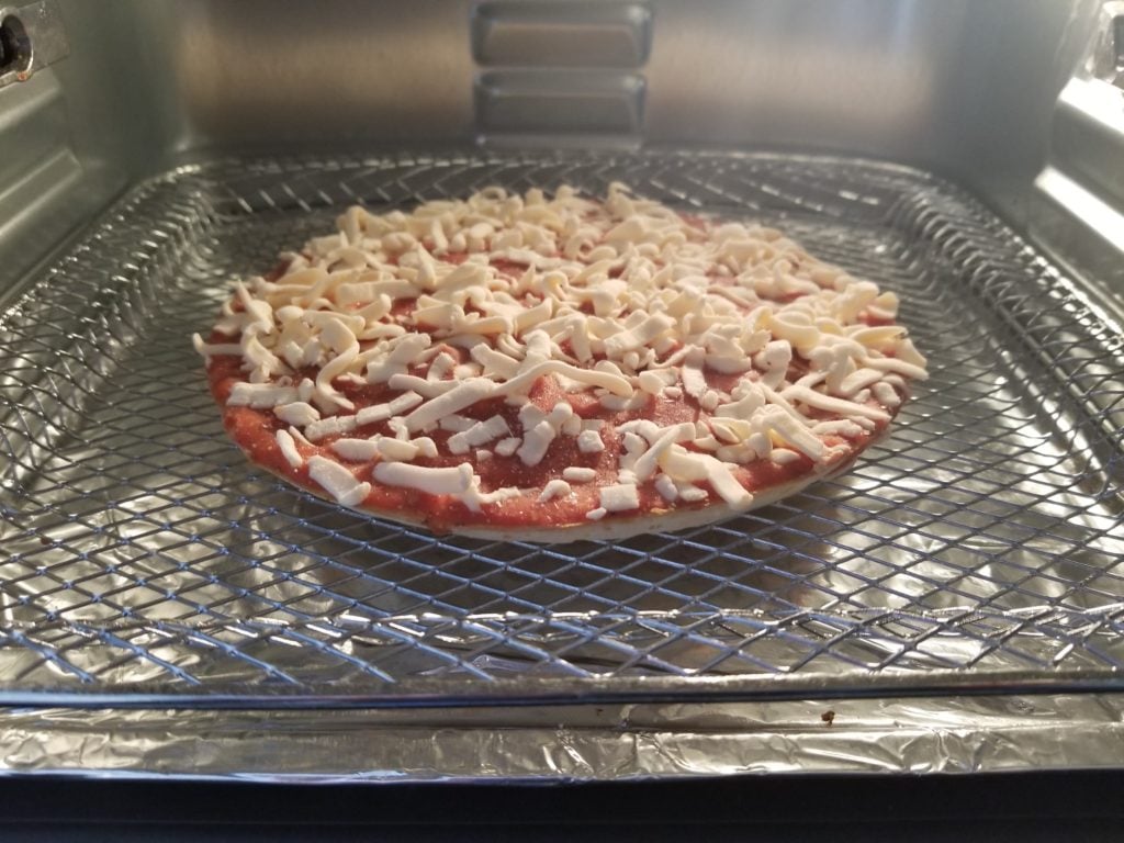 https://tastylicious.com/wp-content/uploads/2021/01/Frozen-Pizza-in-oven-1024x768.jpg