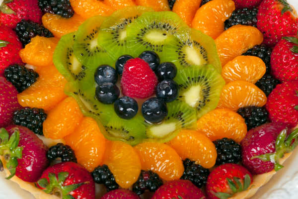 A selection of fruits in a platter that have been glazed