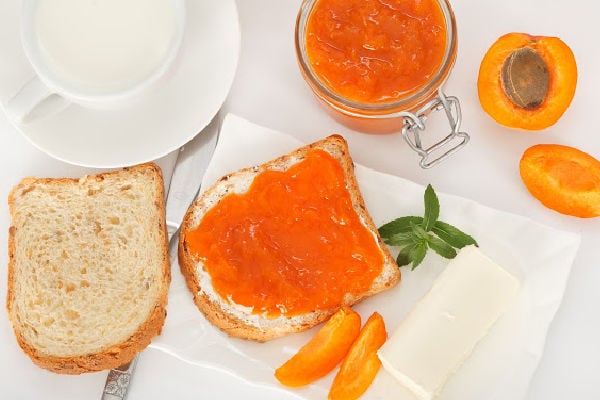 Top down view of apricot jam on toast