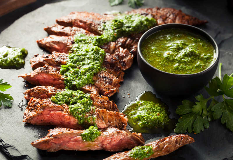Slices of skirt steak with chimichurri