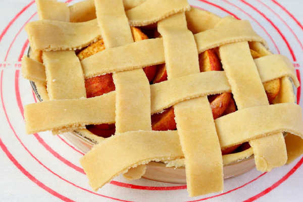 Apple pie ready to bake on a pastry mat