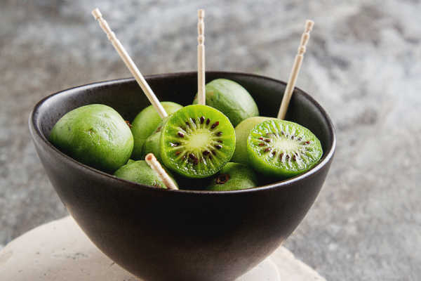 Kiwiberries on picks in a bowl