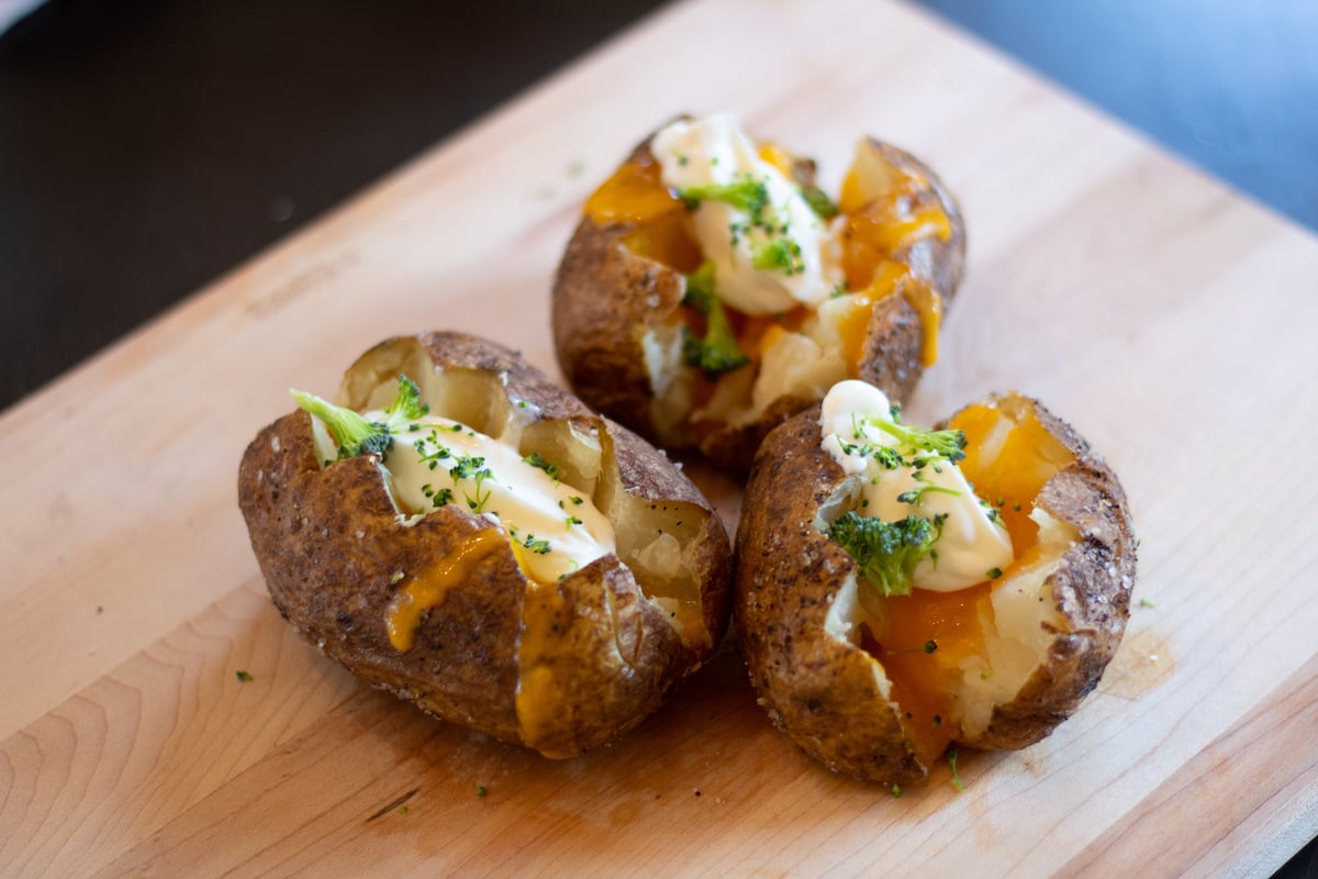 Air fried baked potato topped with cheese, sour cream and broccoli