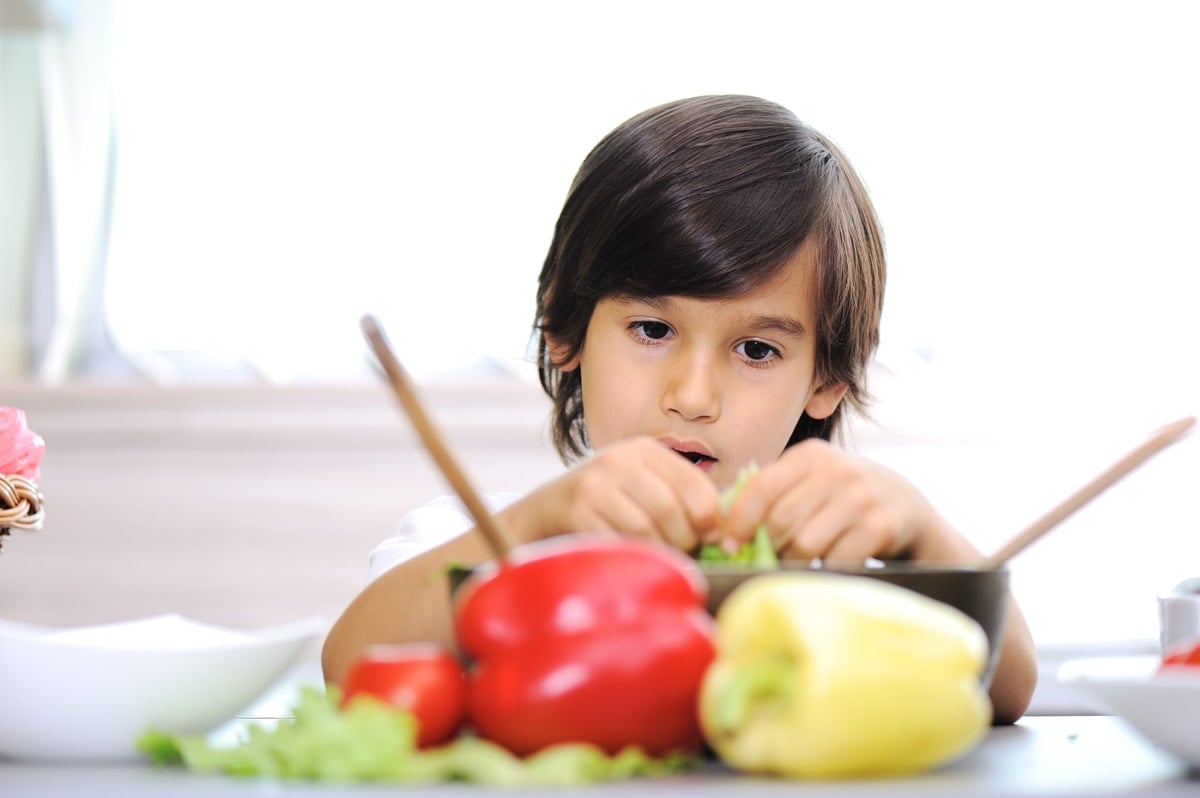 Toddler eating fruit and vegetables