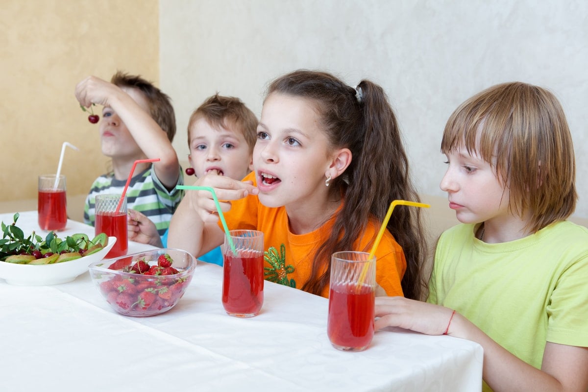 Kids drinking fresh squeezed fruit juice