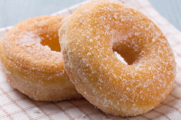 Sugar donuts on a tea towel