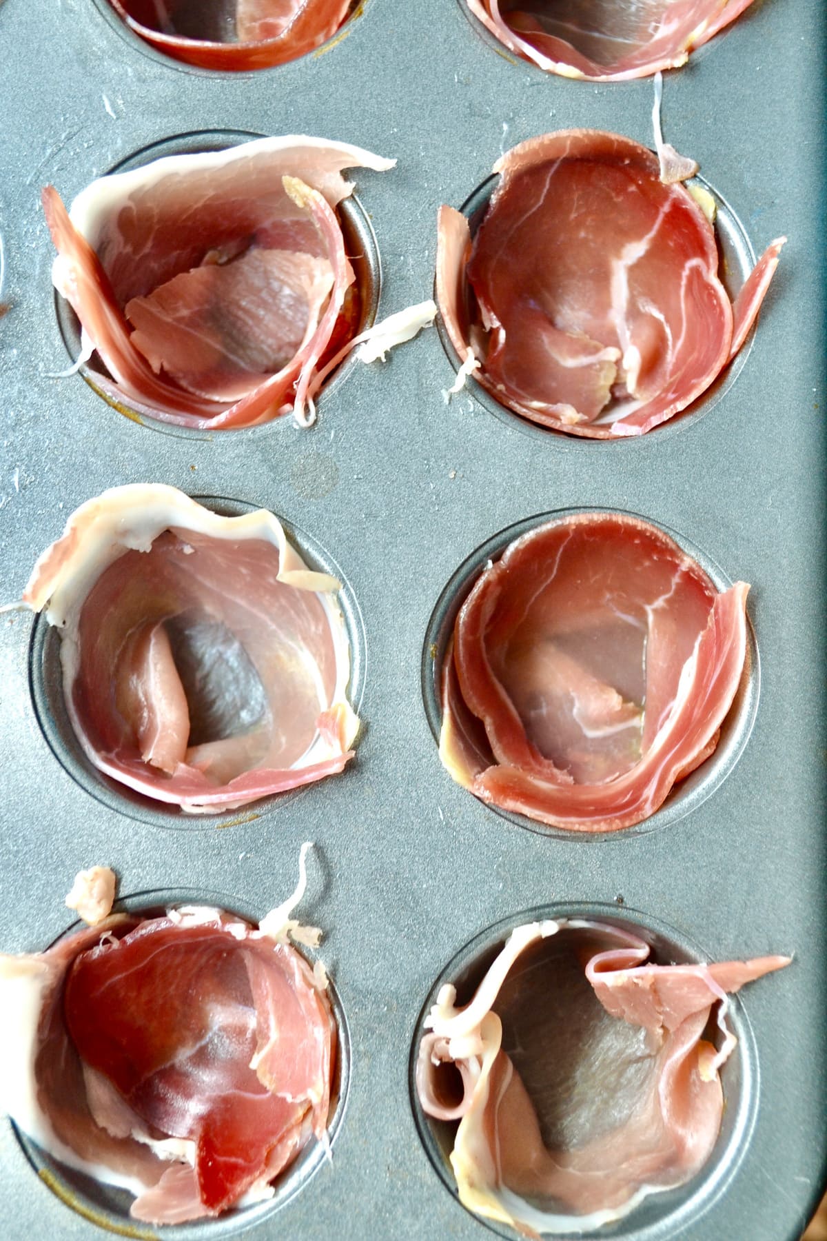 prosciutto egg cups on muffin pan