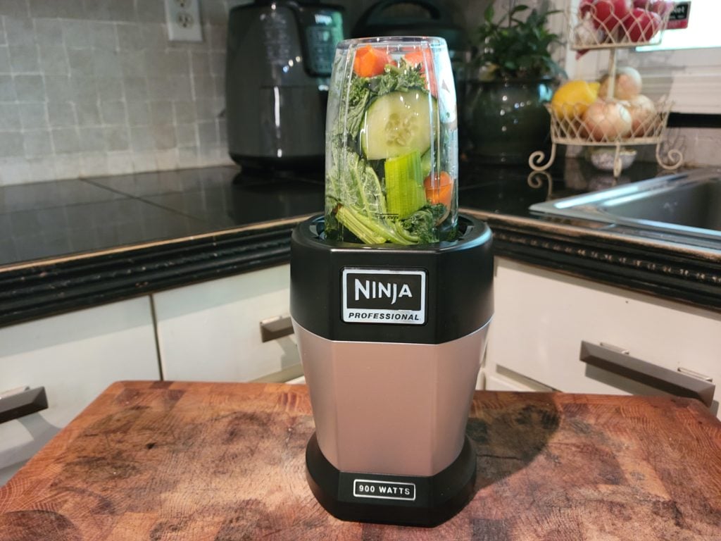 Green smoothie ingredients loaded in the Nutri Ninja Pro.