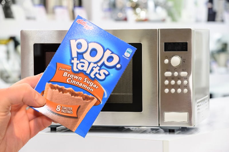 Holding a pack of Pop Tarts in front of a microwave