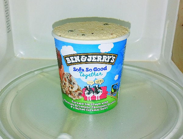 A pint of Ben and Jerry's ice cream in the microwave