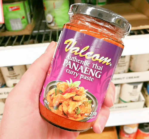 Holding a jar of panaeng curry paste
