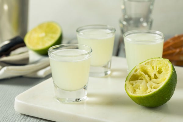 Kamikaze cocktails next to limes