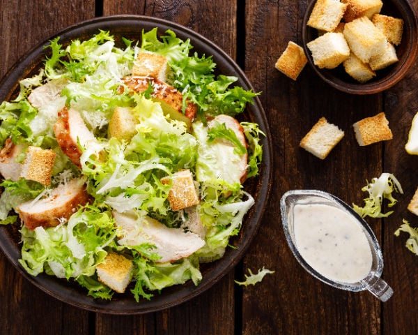 A salad topped with croutons