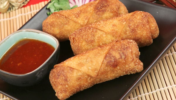 Egg rolls and dipping sauce on a plate