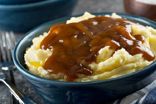 A plate of mashed potato topped with gravy