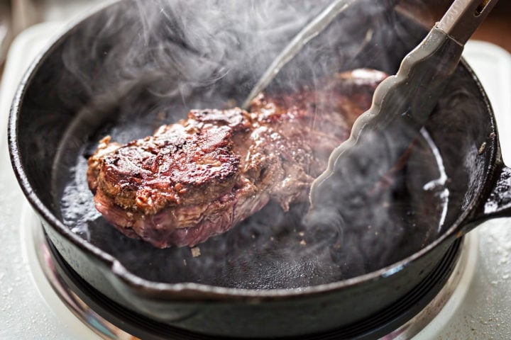 Angus steak fried on vegetable oil on iron cast