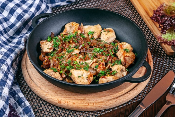 Close up view on served homemade meat and vegetables in cast iron pot