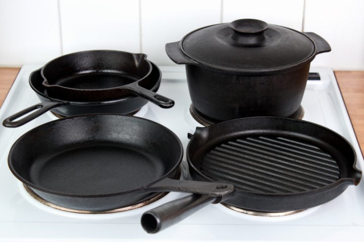 Different cast iron cookware on electric stove