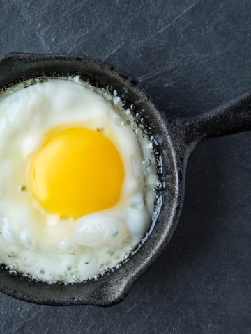 Top view of fried egg in small cast-iron skillet