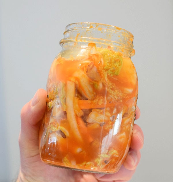 Kimchi in a jar with lid off