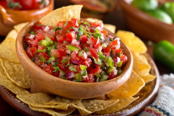 Pico de Gallo in a bowl next to tortilla chips