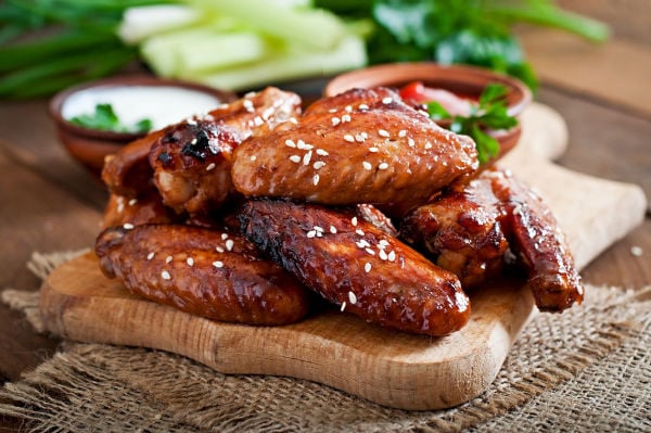 Teriyaki chicken wings on a chopping board