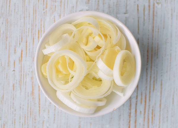 A bowl of raw leek stem chopped