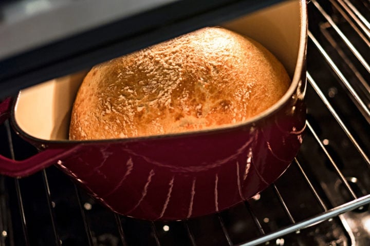 loaf of bread inside a crock pot in the oven safe