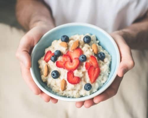 Breakfast Oatmeal Porridge Bowl With Berries and Nuts