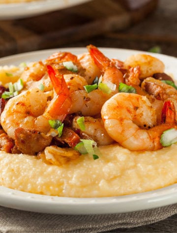 A bowl of cooked grits topped with shrimp