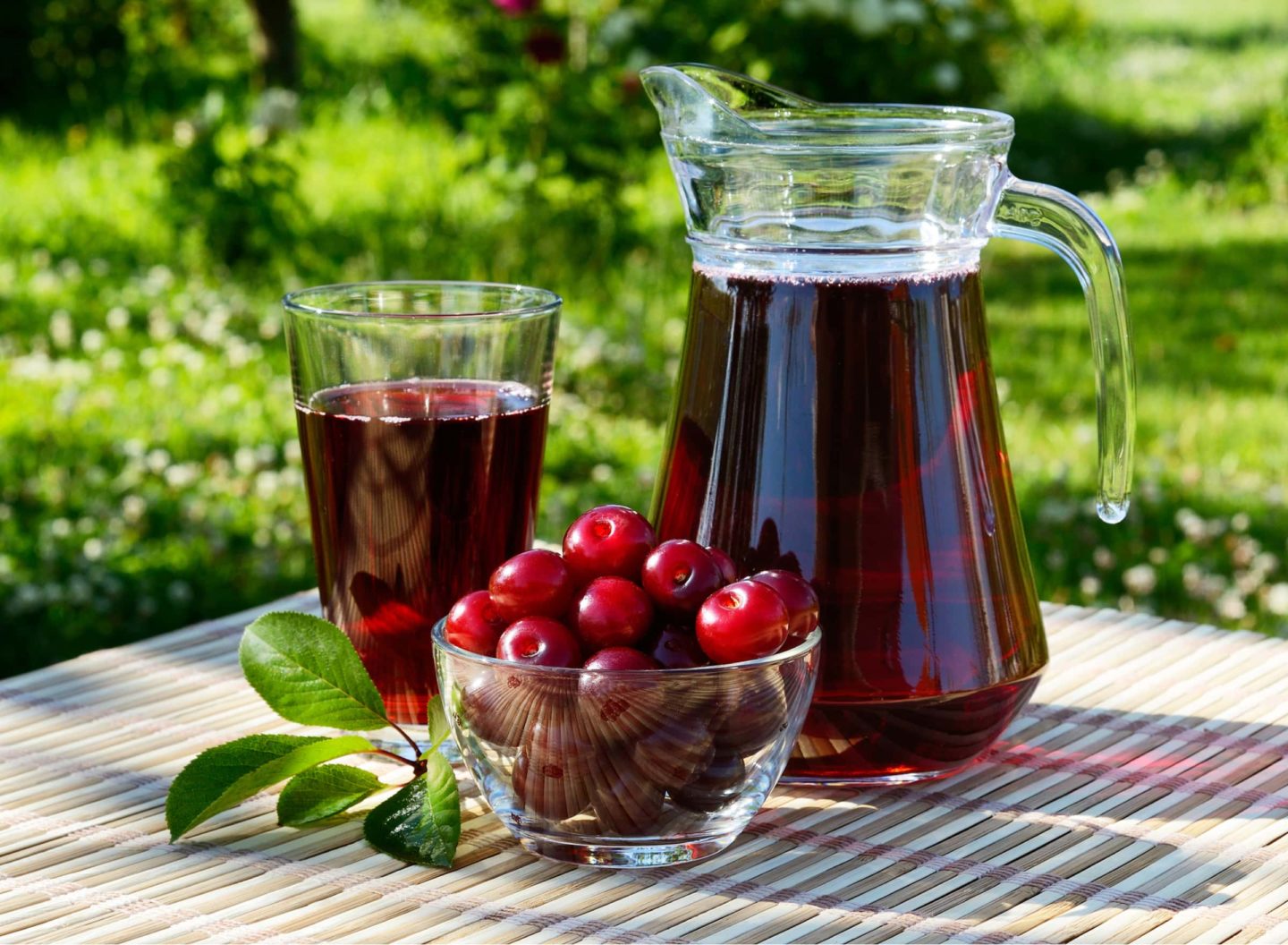 cherry juice in a glass and pitcher