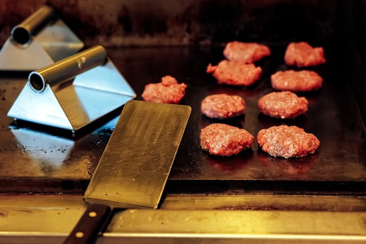 a griddle spatula used as hamburger turner and food scraper