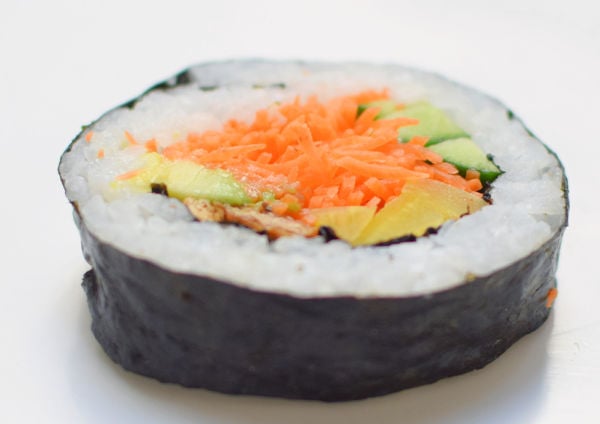 Vegetable maki roll on white background