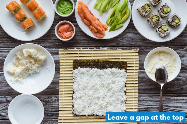 Rice spread out evenly over a nori sheet