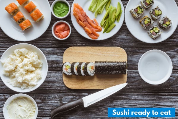 A sliced sushi roll on a chopping board