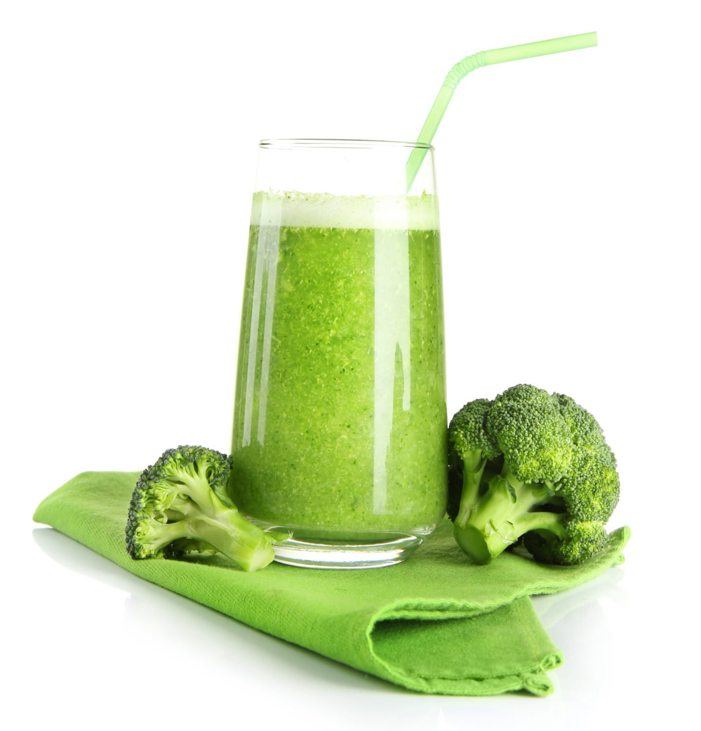 a glass of broccoli juice on a green napkin