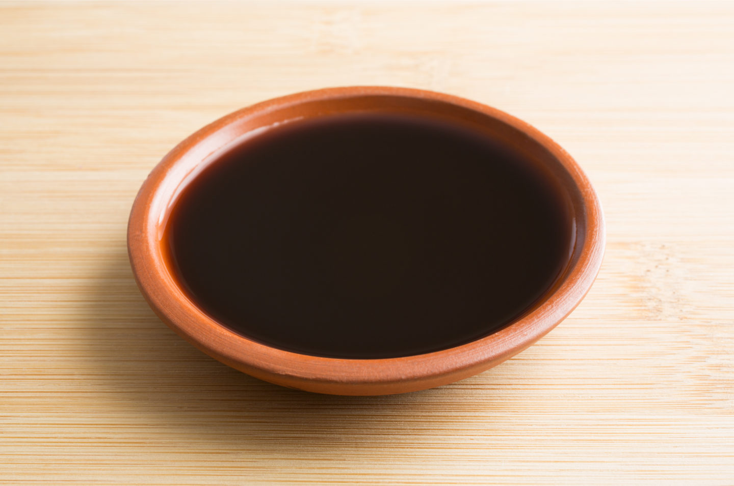 liquid smoke in a small wooden bowl