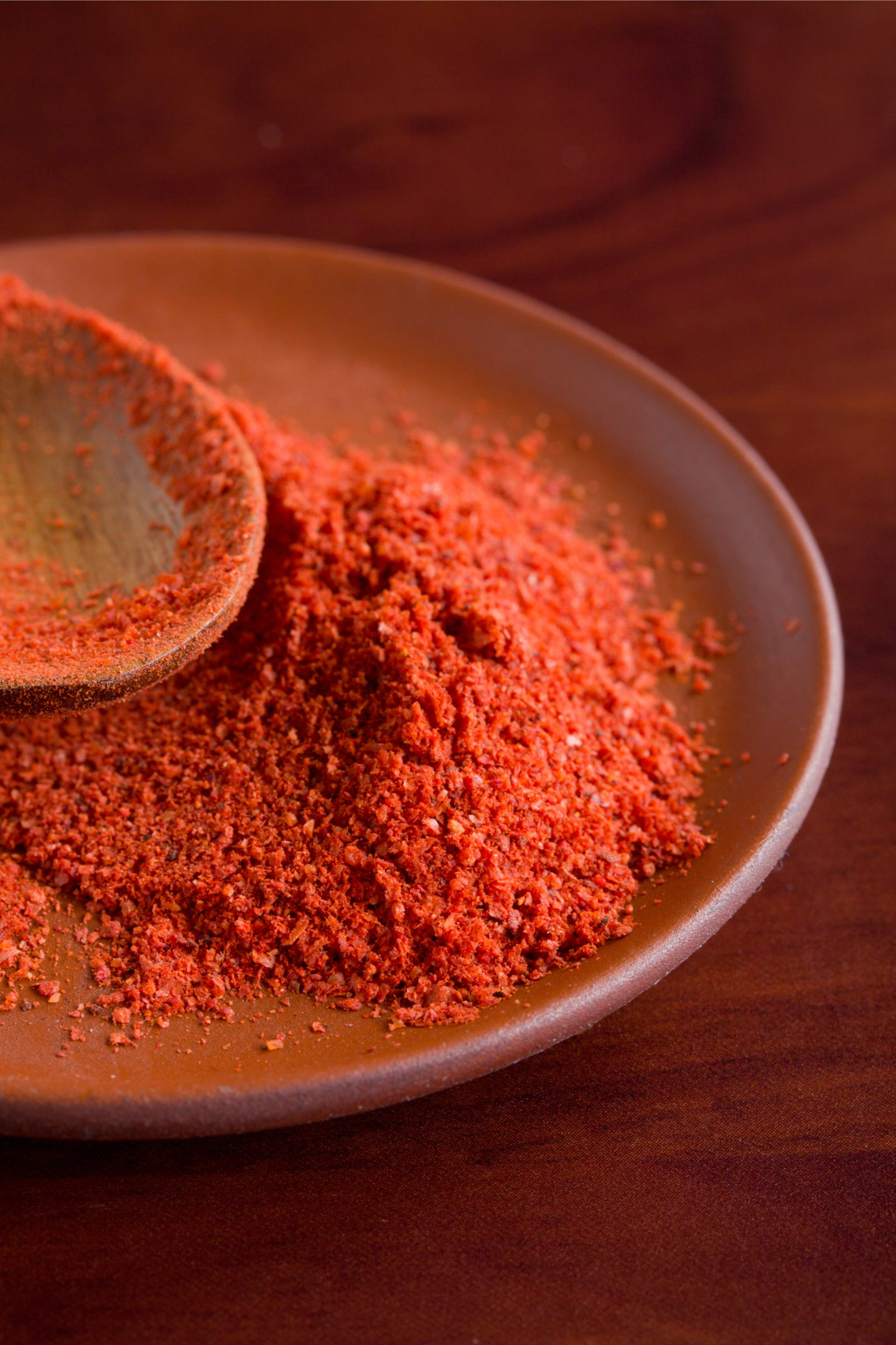 sweet paprika in bowl with spoon