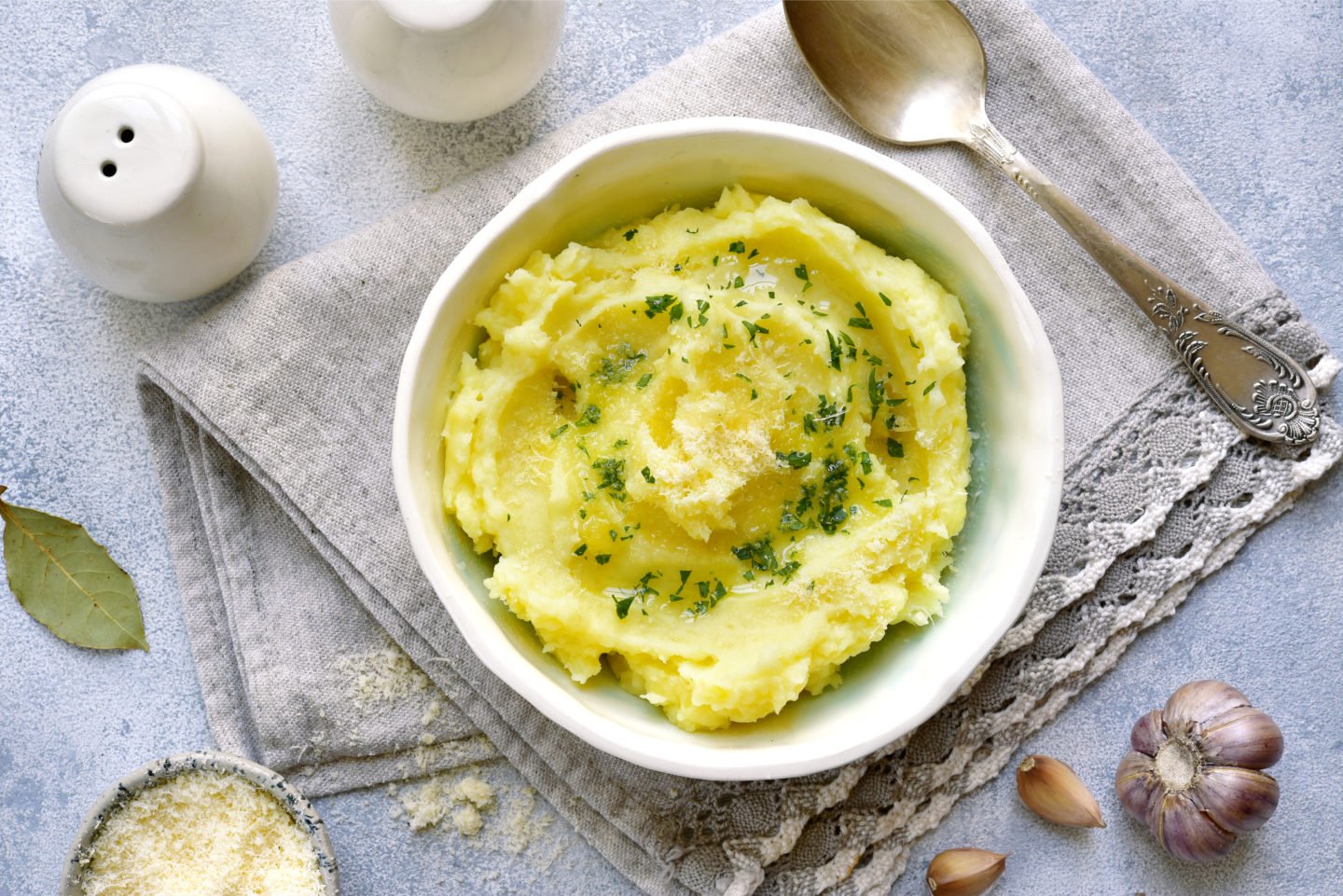 mashed potato in bowl with parmesan and olive oil