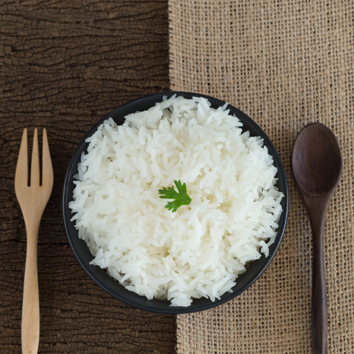 white regular rice with spoon and fork