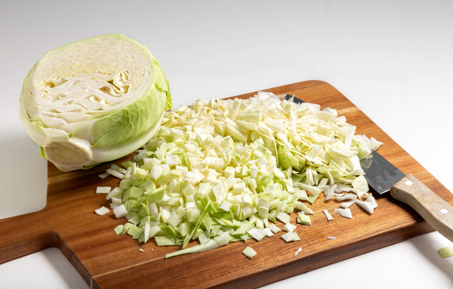 chopped cabbage on wood cutting board