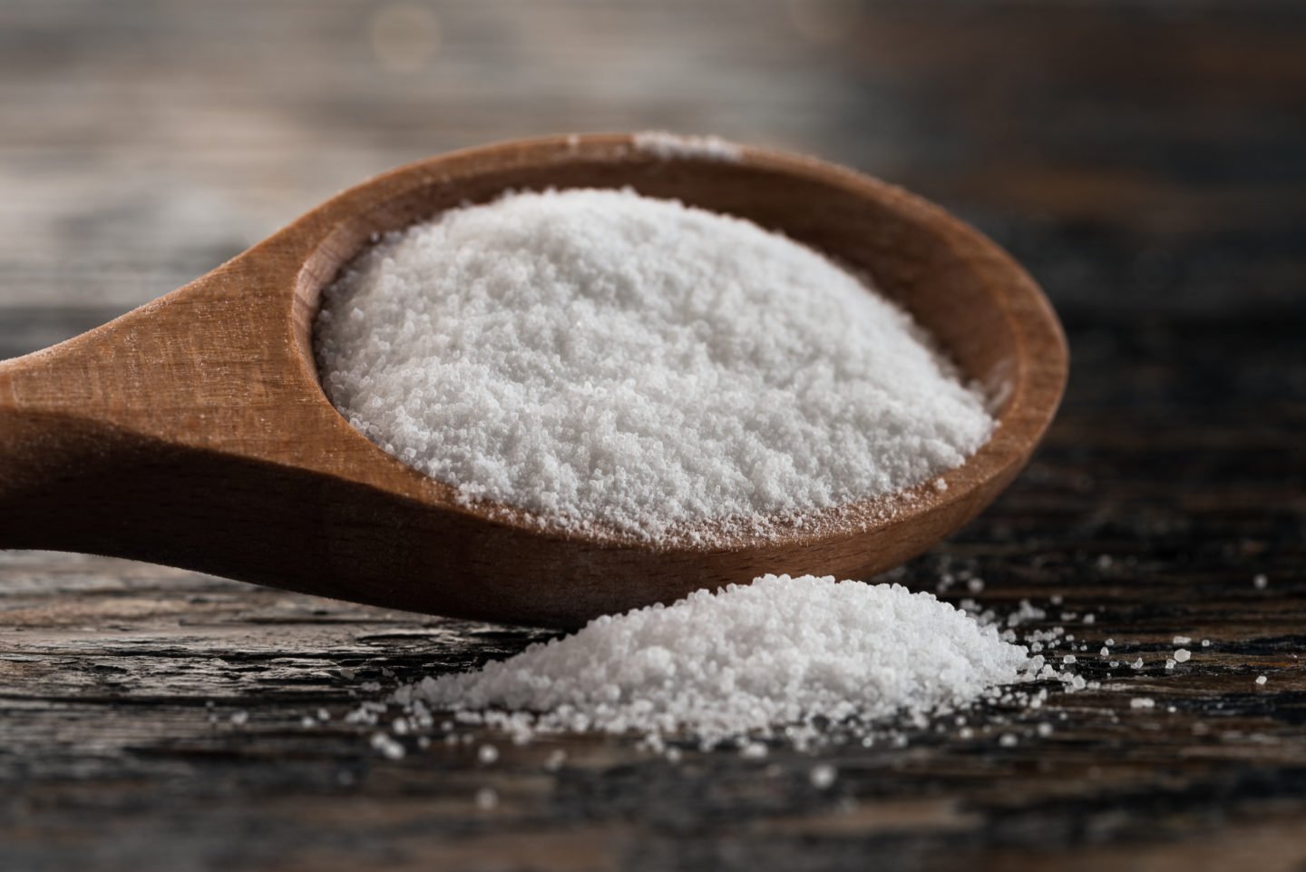 citric acid powder on a wooden spoon