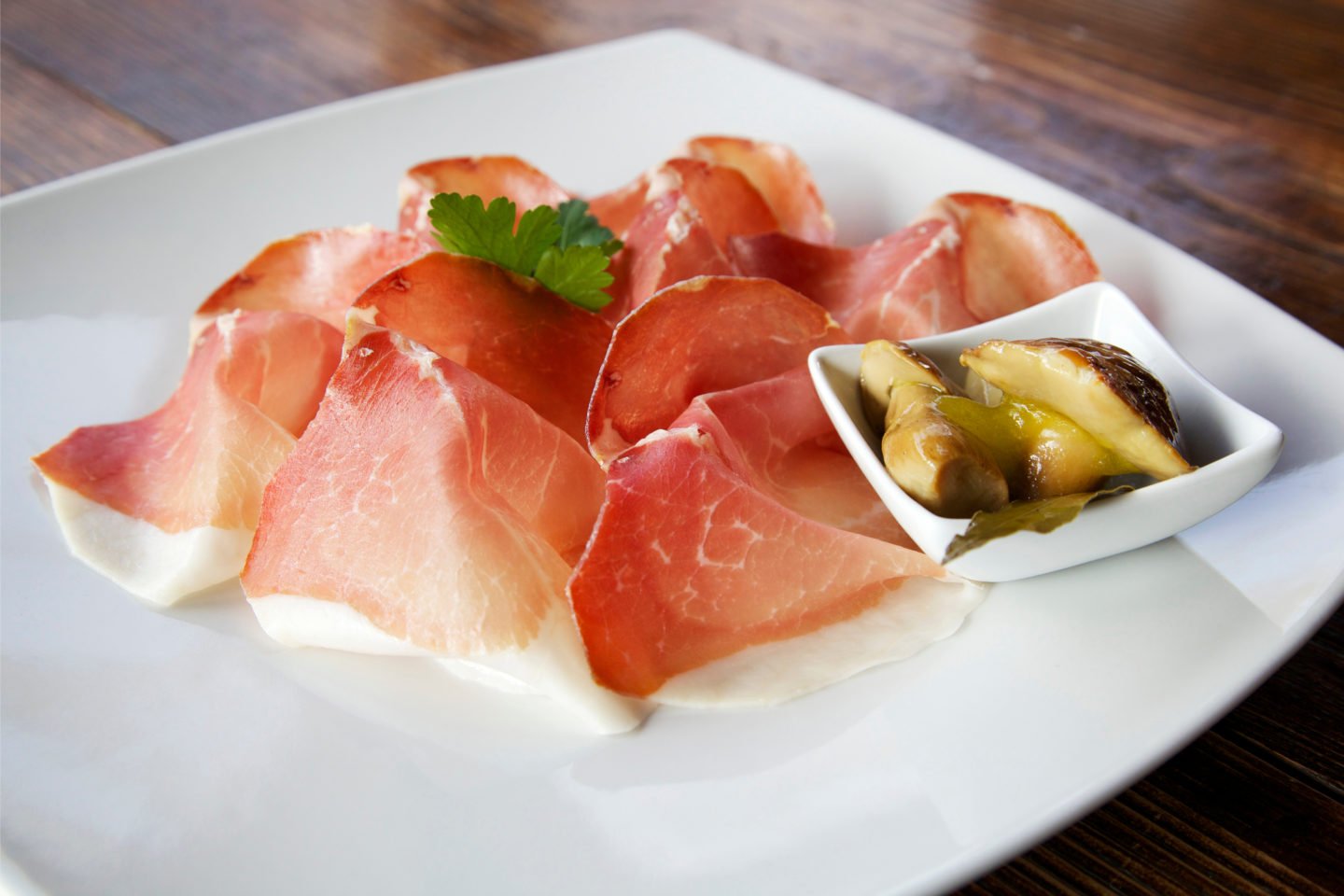 slices of culatello on plate