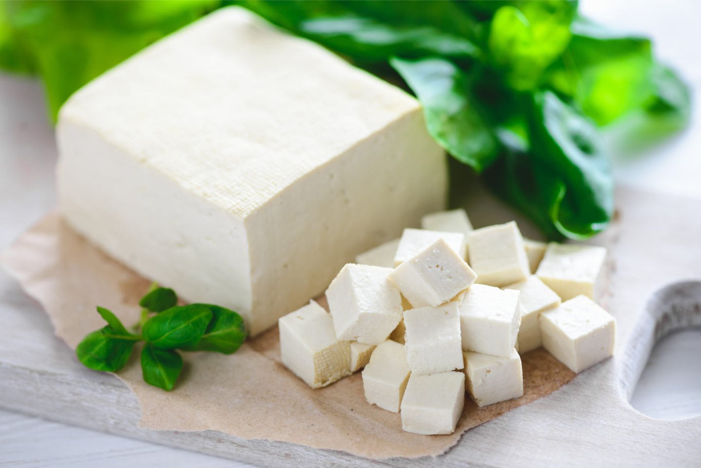 whole and diced tofu on cutting board